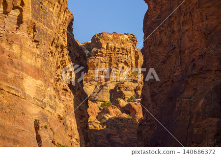Panoramic view of Siq Gorge canyon cliffs and rocks at daytime, Petra, Wadi Musa, Jordan Panoramic view of Siq Gorge canyon cliffs and rocks at daytime, Petra, Wadi Musa, Jordan 140686372