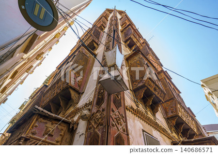 Close up view of the corner of building from bottom to top in the old city of Jeddah, Saudi Arabia, at daytime Close up view of the corner of building from bottom to top in the old city of Jeddah, Saudi Arabia, at daytime 140686571