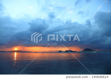 Seascape at sunshine. Lighthouse and sailings on the coast. Seaside town of Turgutreis and spectacular sunshine. Long Exposure shoot. Seascape at sunshine. Lighthouse and sailings on the coast. Seaside town of Turgutreis and spectacular sunshine. Long Exposure shoot. 140686624