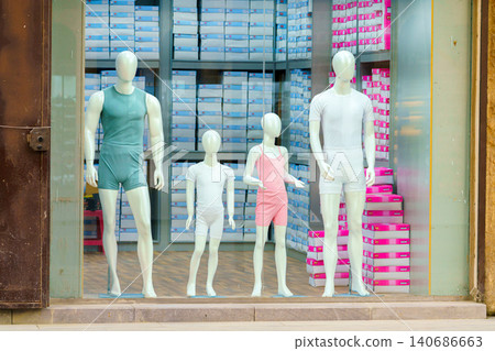 Jeddah, Saudi Arabia - Mar 08 2023, a four mannequins, two adults and two children, stand on showcase in different outfits, Jeddah, Saudi Arabia Jeddah, Saudi Arabia - Mar 08 2023, a four mannequins, two adults and two children, stand on showcase in different outfits, Jeddah, Saudi Arabia 140686663