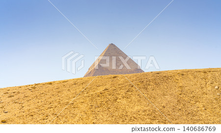 Giza, Egypt - Mar 11 2023, panoramic view of the top of the Pyramid of Khafre, in the foreground there is a sandy hill, at daytime, Giza, Egypt Giza, Egypt - Mar 11 2023, panoramic view of the top of the Pyramid of Khafre, in the foreground there is a sandy hill, at daytime, Giza, Egypt 140686769
