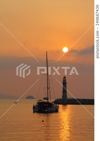 Seascape at sunshine. Lighthouse and sailings on the coast. Seaside town of Turgutreis and spectacular sunshine Seascape at sunshine. Lighthouse and sailings on the coast. Seaside town of Turgutreis and spectacular sunshine 140687436