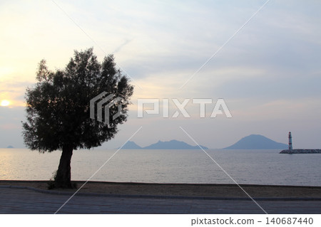 Seascape at sunshine. Lighthouse and sailings on the coast. Seaside town of Turgutreis and spectacular sunshine 140687440