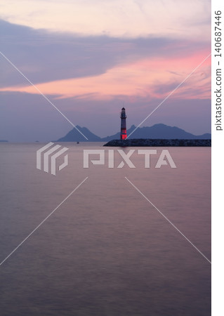 Seascape at sunshine. Lighthouse and sailings on the coast. Seaside town of Turgutreis and spectacular sunshine Seascape at sunshine. Lighthouse and sailings on the coast. Seaside town of Turgutreis and spectacular sunshine 140687446
