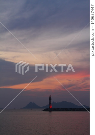 Seascape at sunshine. Lighthouse and sailings on the coast. Seaside town of Turgutreis and spectacular sunshine Seascape at sunshine. Lighthouse and sailings on the coast. Seaside town of Turgutreis and spectacular sunshine 140687447