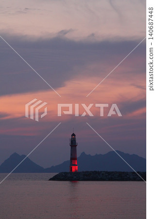 Seascape at sunshine. Lighthouse and sailings on the coast. Seaside town of Turgutreis and spectacular sunshine Seascape at sunshine. Lighthouse and sailings on the coast. Seaside town of Turgutreis and spectacular sunshine 140687448