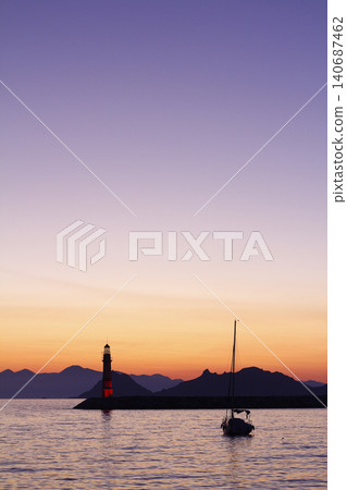 Seascape at sunshine. Lighthouse and sailings on the coast. Seaside town of Turgutreis and spectacular sunshine Seascape at sunshine. Lighthouse and sailings on the coast. Seaside town of Turgutreis and spectacular sunshine 140687462