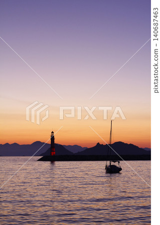 Seascape at sunshine. Lighthouse and sailings on the coast. Seaside town of Turgutreis and spectacular sunshine Seascape at sunshine. Lighthouse and sailings on the coast. Seaside town of Turgutreis and spectacular sunshine 140687463