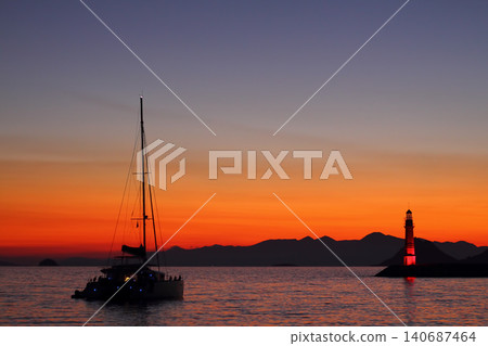 Seascape at sunshine. Lighthouse and sailings on the coast. Seaside town of Turgutreis and spectacular sunshine 140687464