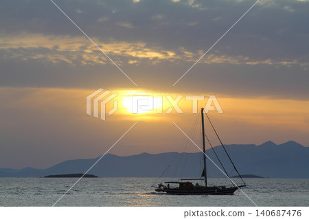 Alone sailboat at sunset. Atmospheric seascape with reflection 140687476