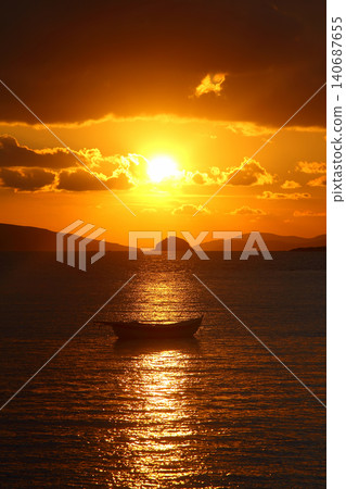 Alone sailboat at sunset. Atmospheric seascape with reflection Alone sailboat at sunset. Atmospheric seascape with reflection 140687655