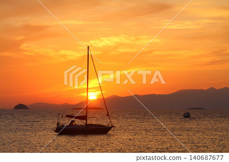 Alone sailboat at sunset. Atmospheric seascape with reflection Alone sailboat at sunset. Atmospheric seascape with reflection 140687677