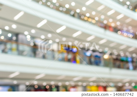 Defocused shopping mall interior bright lights modern architecture ideal as retail background for business advertising marketing commercial design projects Defocused shopping mall interior bright lights modern architecture ideal as retail background for business advertising marketing commercial design projects 140687742