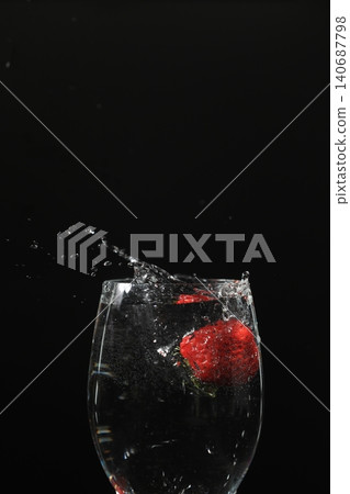 Strawberries falling into the water and splashes of water 140687798