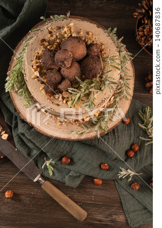 Delicious naked chocolate and hazelnuts cake on table rustic wood kitchen countertop. Top view. Flat lay Delicious naked chocolate and hazelnuts cake on table rustic wood kitchen countertop. Top view. Flat lay 140687836