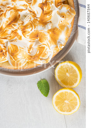 Lemon tart pie with meringue cream. Traditional American cake. Homemade baking. Copy space. Lemon tart pie with meringue cream. Traditional American cake. Homemade baking. Copy space. 140687844