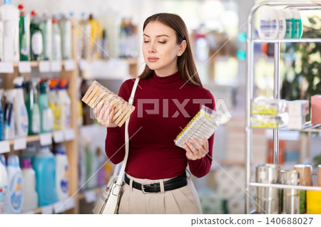 Woman choosing clothespins for laundry Woman choosing clothespins for laundry 140688027