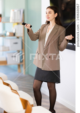 young woman in business clothes gives a presentation 140688067