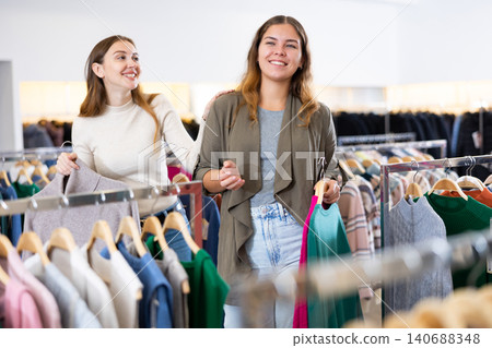 Two women shopping warm clothes in store Two women shopping warm clothes in store 140688348