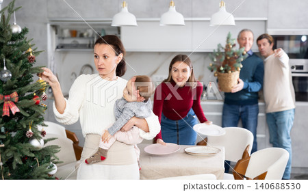 Woman decorating Christmas tree Woman decorating Christmas tree 140688530