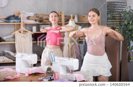 Dressmakers warming up together during a break Dressmakers warming up together during a break 140688564