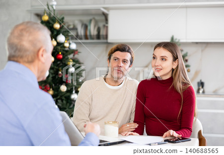 Couple discussing deal with salesman in kitchen Couple discussing deal with salesman in kitchen 140688565