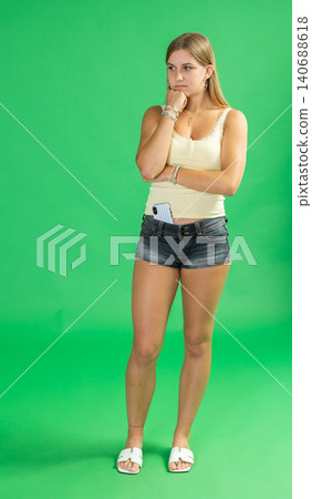 Sad thoughtful teenage girl in front of green screen 140688618