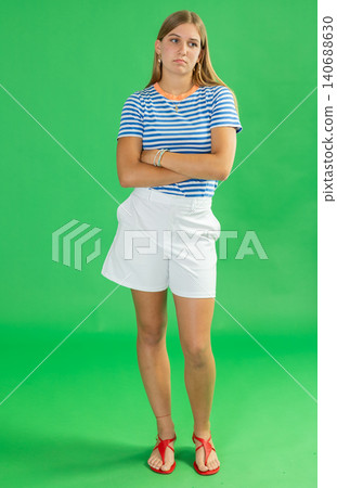 Sad teenage girl white shorts is upset about problems that have arisen. Chroma key compositing Sad teenage girl white shorts is upset about problems that have arisen. Chroma key compositing 140688630