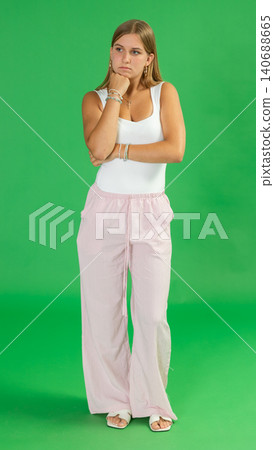 Sad thoughtful teenage girl in front of green screen 140688665