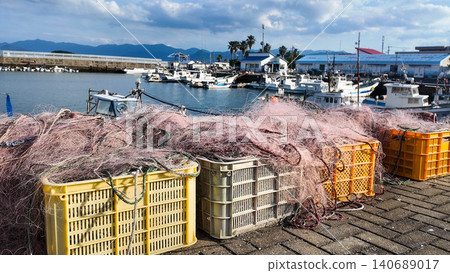 Commercial fishing nets on plastic crates at a traditional fishing harbor. 140689017