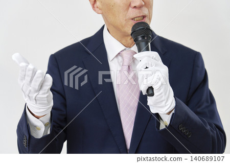A candidate giving a speech against a white background; their face is not visible. A candidate giving a speech against a white background; their face is not visible. 140689107