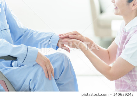 Caregivers assisting elderly people in wheelchairs Caregivers assisting elderly people in wheelchairs 140689242