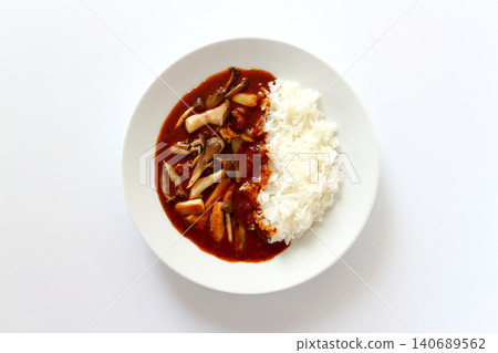 Mushroom curry rice viewed from directly above against a white background. Mushroom curry rice viewed from directly above against a white background. 140689562
