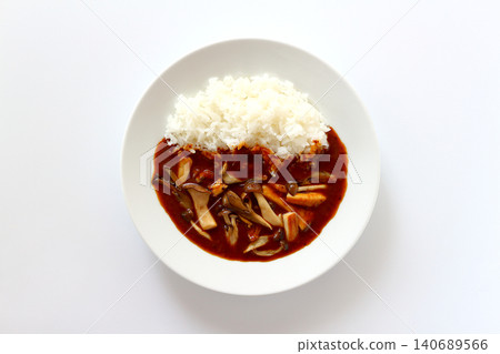 Mushroom curry rice viewed from directly above against a white background. Mushroom curry rice viewed from directly above against a white background. 140689566