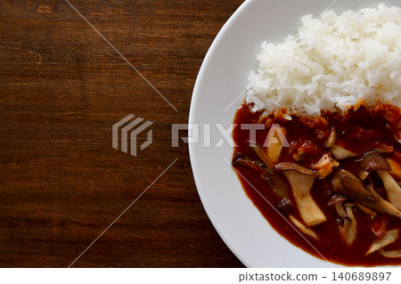 Mushroom curry rice with a table background viewed from directly above. Mushroom curry rice with a table background viewed from directly above. 140689897