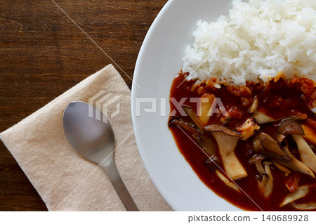 Mushroom curry rice with a table background viewed from directly above. Mushroom curry rice with a table background viewed from directly above. 140689928