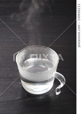 Hot water poured into a glass cup Hot water poured into a glass cup 140690211