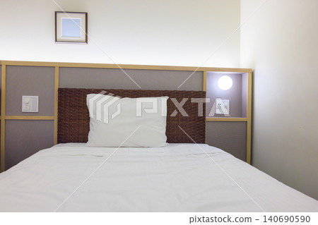 A clean bed and white pillows in the hotel room. A clean bed and white pillows in the hotel room. 140690590