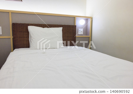 A clean bed and white pillows in the hotel room. A clean bed and white pillows in the hotel room. 140690592