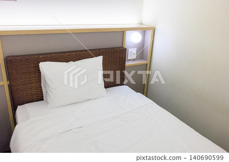 A clean bed and white pillows in the hotel room. A clean bed and white pillows in the hotel room. 140690599
