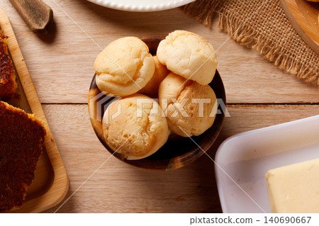 Homemade cheese bread in a wooden bowl as part of a traditional Brazilian breakfast on a rustic table Homemade cheese bread in a wooden bowl as part of a traditional Brazilian breakfast on a rustic table 140690667