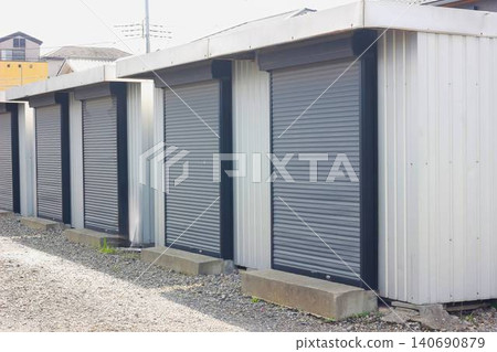 Gray, shuttered container-type storage units lined up on the outdoor premises. Gray, shuttered container-type storage units lined up on the outdoor premises. 140690879