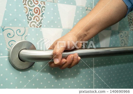 Asian elderly woman patient use toilet bathroom handle security in nursing hospital, healthy strong medical. Asian elderly woman patient use toilet bathroom handle security in nursing hospital, healthy strong medical. 140690966