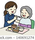 A female caregiver assisting with meals. 140691274