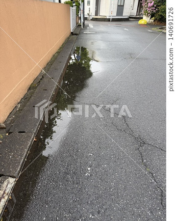 puddle beside the drain puddle beside the drain 140691726