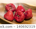 A rose apple image placed on a wooden plate 140692319