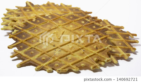 Group of pizzelles on white background. Spiced biscuits of Italian origin. Group of pizzelles on white background. Spiced biscuits of Italian origin. 140692721