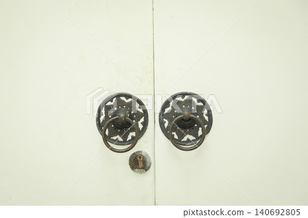 Two metal handles on a wooden door in Bali Two metal handles on a wooden door in Bali 140692805