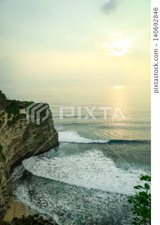 Waves crash against the cliffs as the sun sets in Bali Waves crash against the cliffs as the sun sets in Bali 140692846