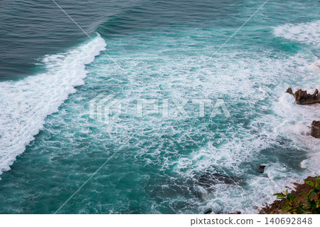 Waves roll onto the rocks along Balis coastline during sunset Waves roll onto the rocks along Balis coastline during sunset 140692848